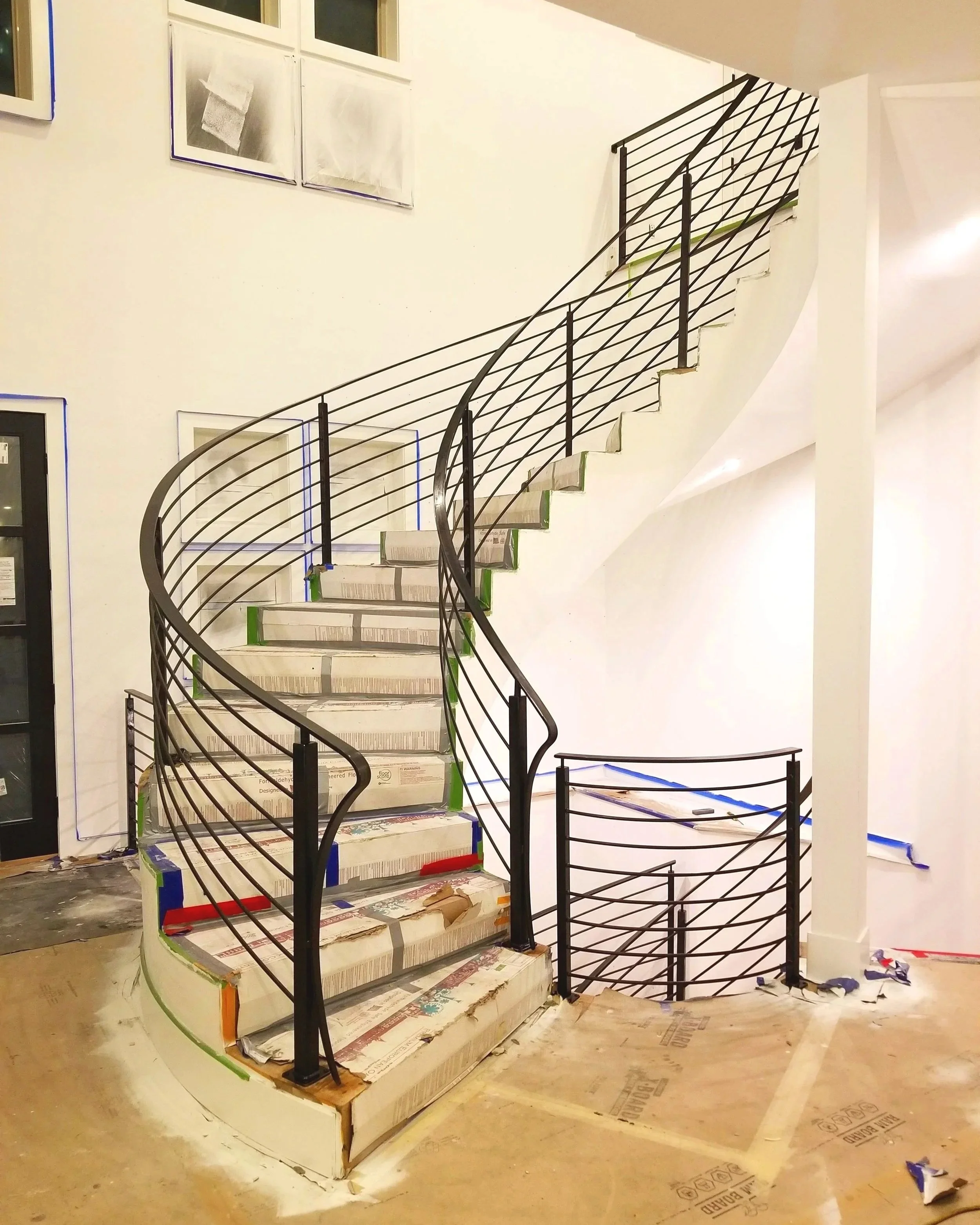 Spiral staircase with metal railing in a new build home