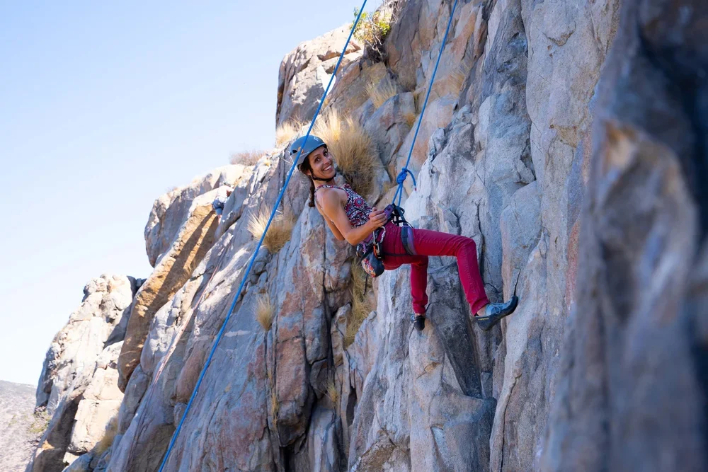 Intro to outdoor rock climbing class for beginners learning on natural rock