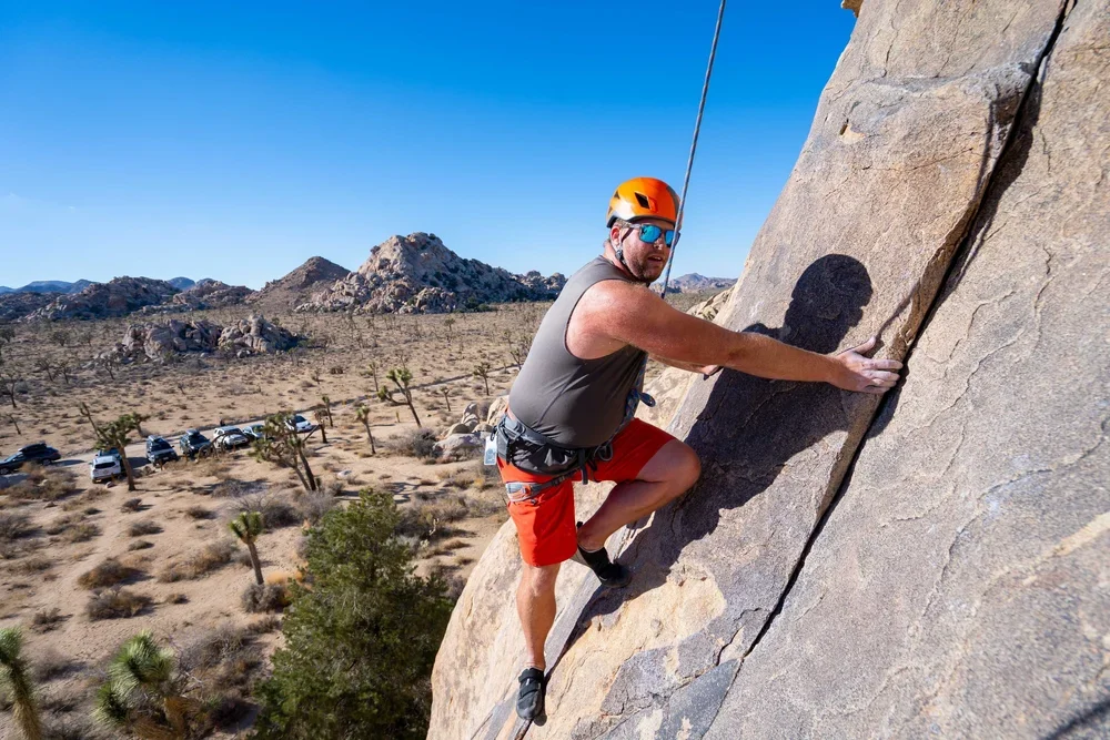 Guided climbing session on sunlit granite in Joshua Tree