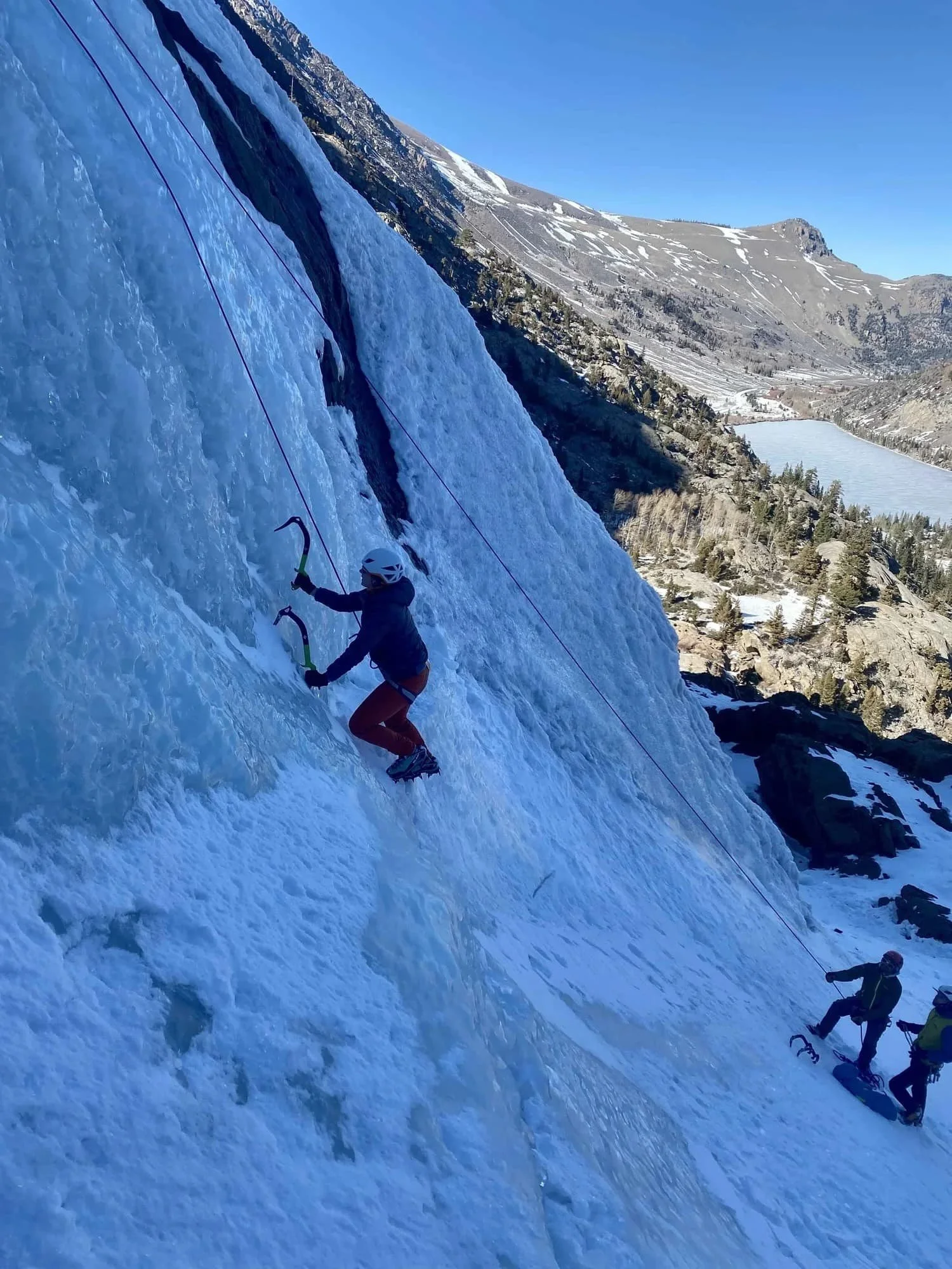Guided beginner ice climbing program on frozen alpine routes