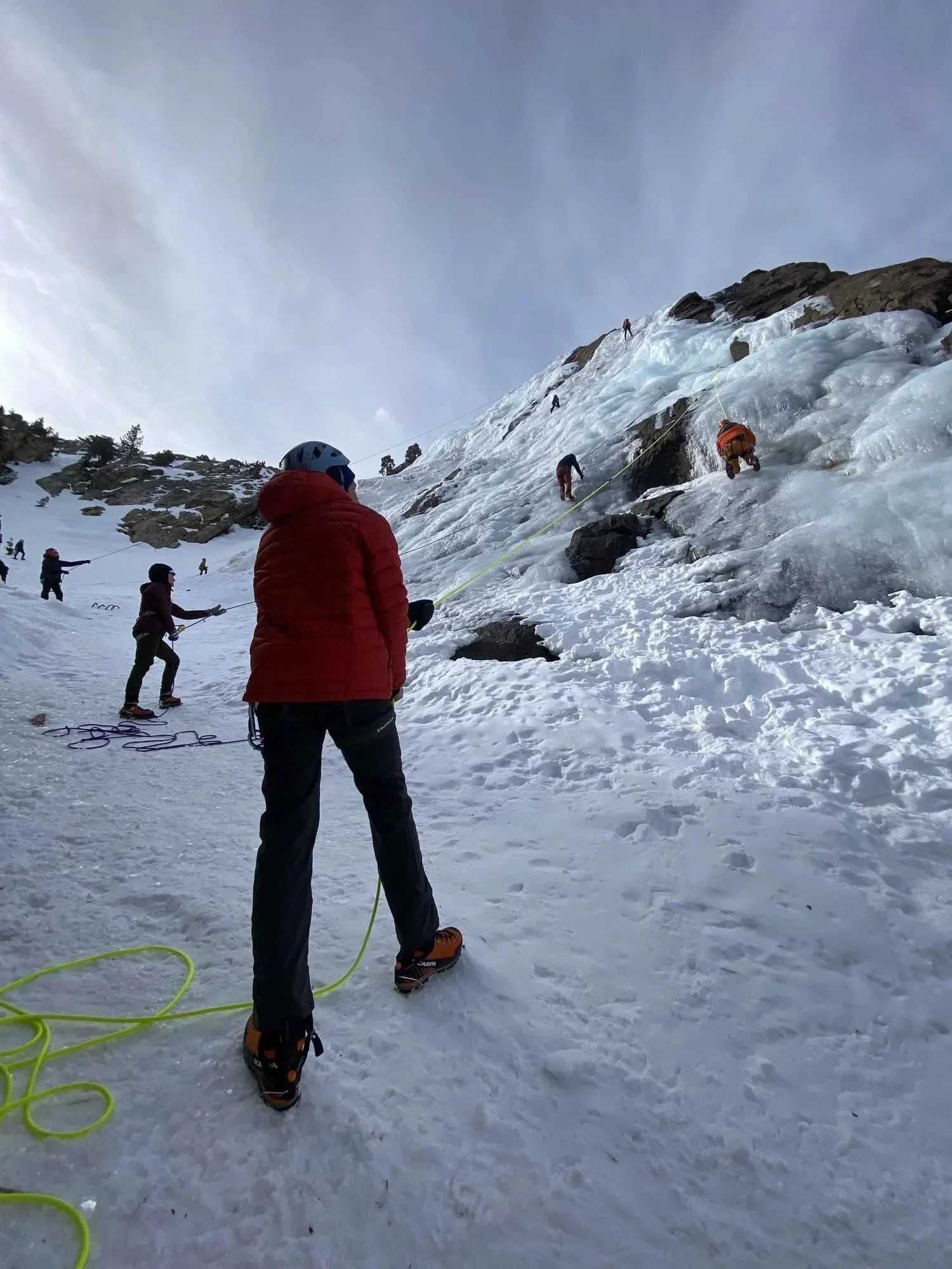 Certified guides teaching introductory ice climbing techniques