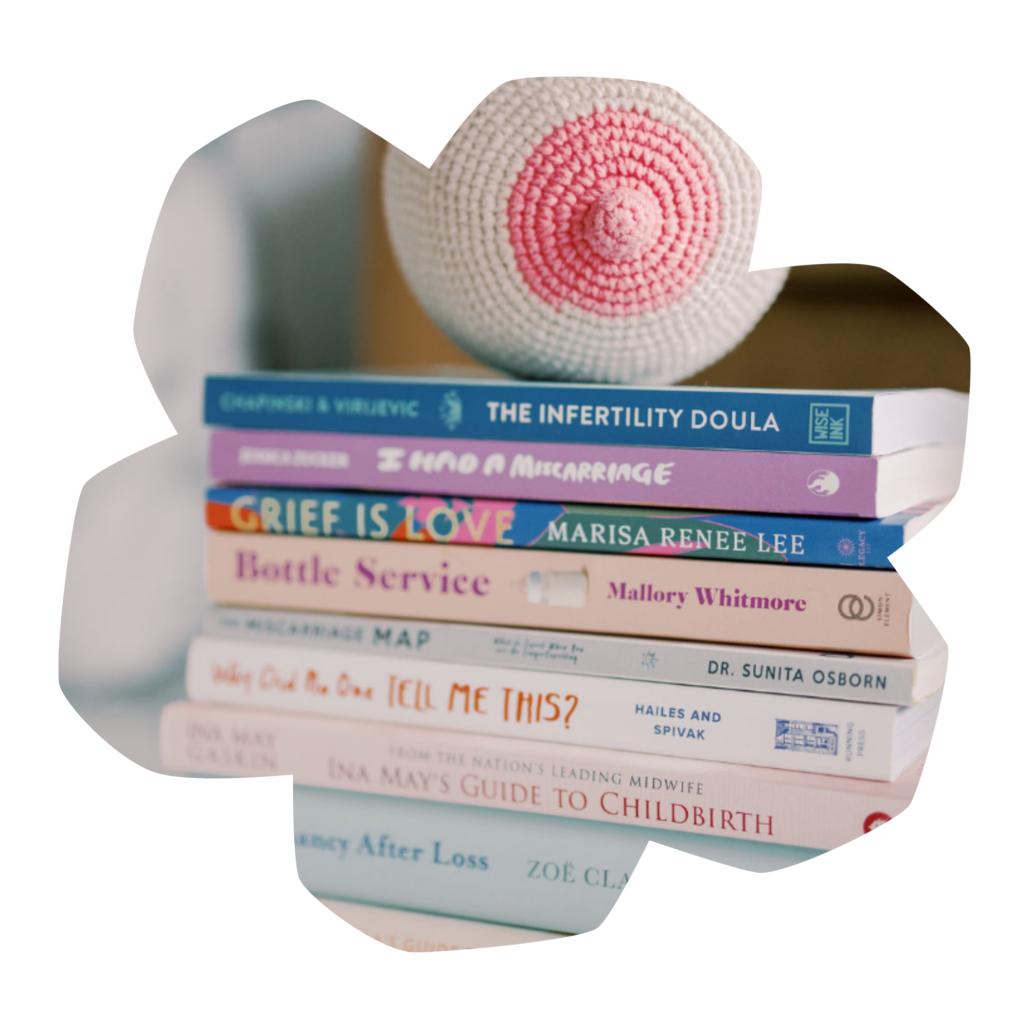 Stack of colorful books with titles related to fertility, miscarriage, grief, childbirth, and emotional health.
