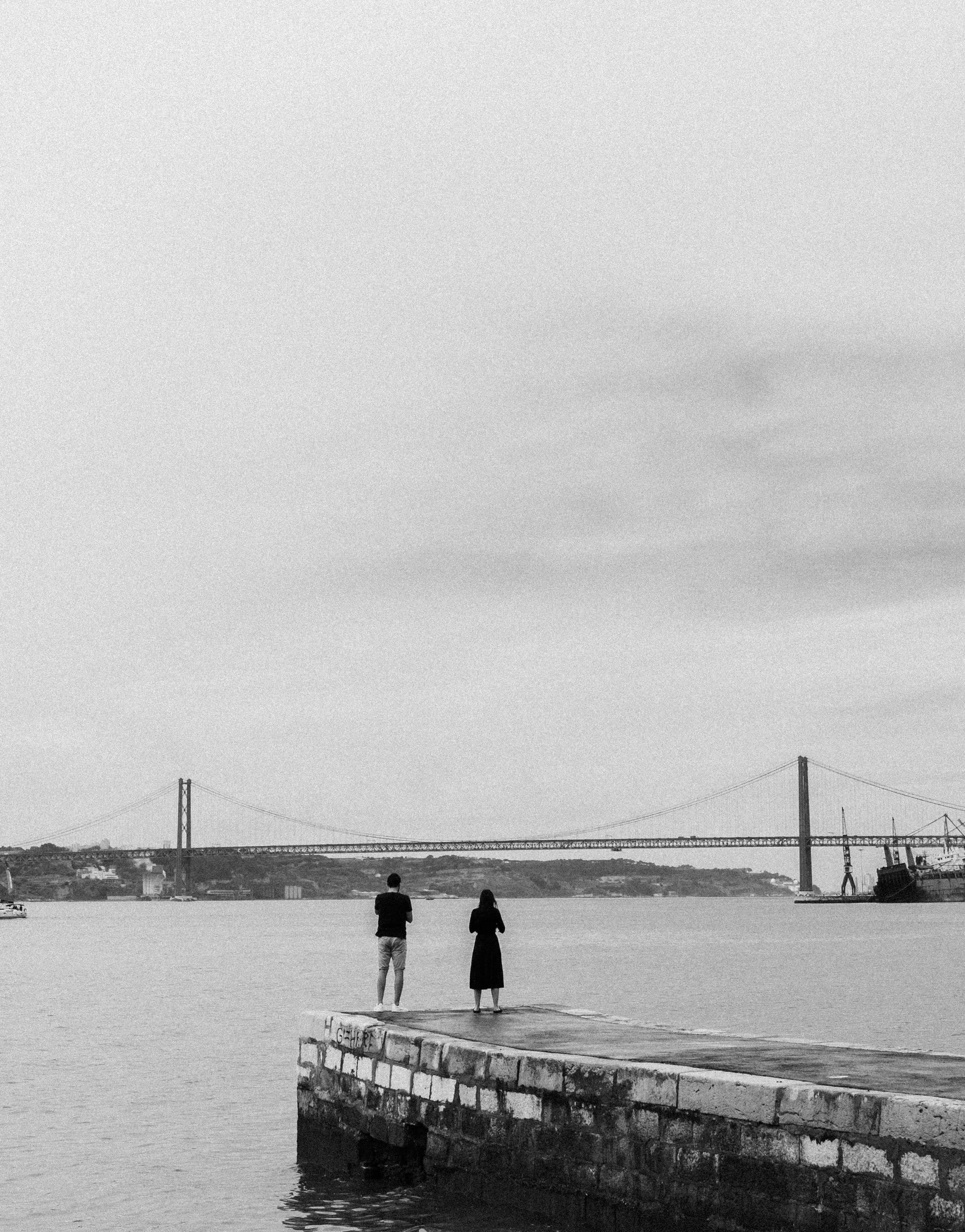 Two people standing on a dock