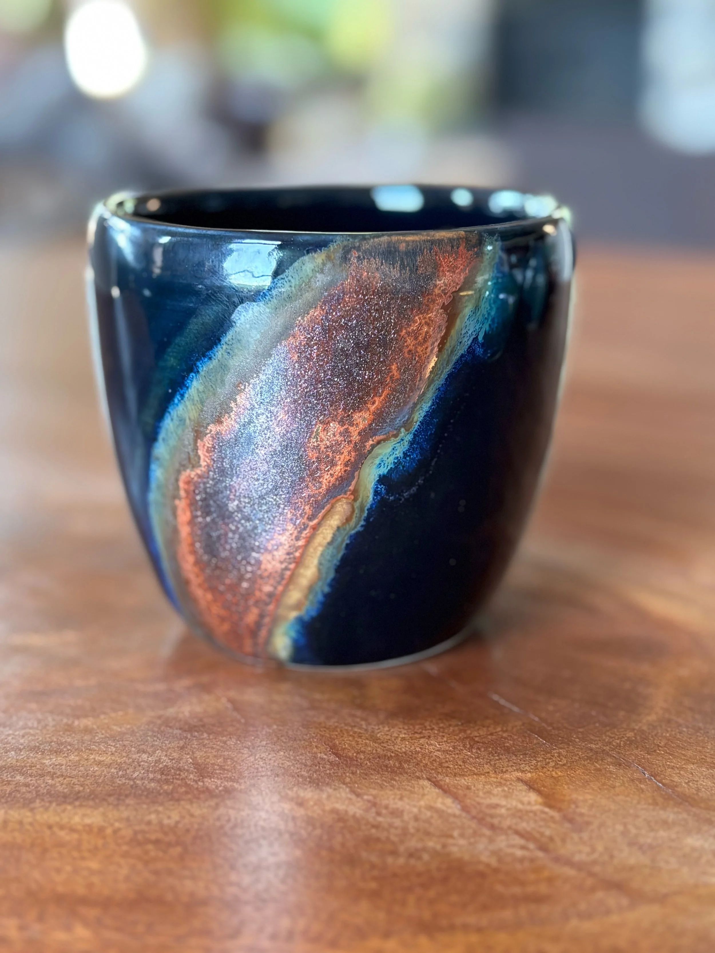 Black cup with copperized swoosh