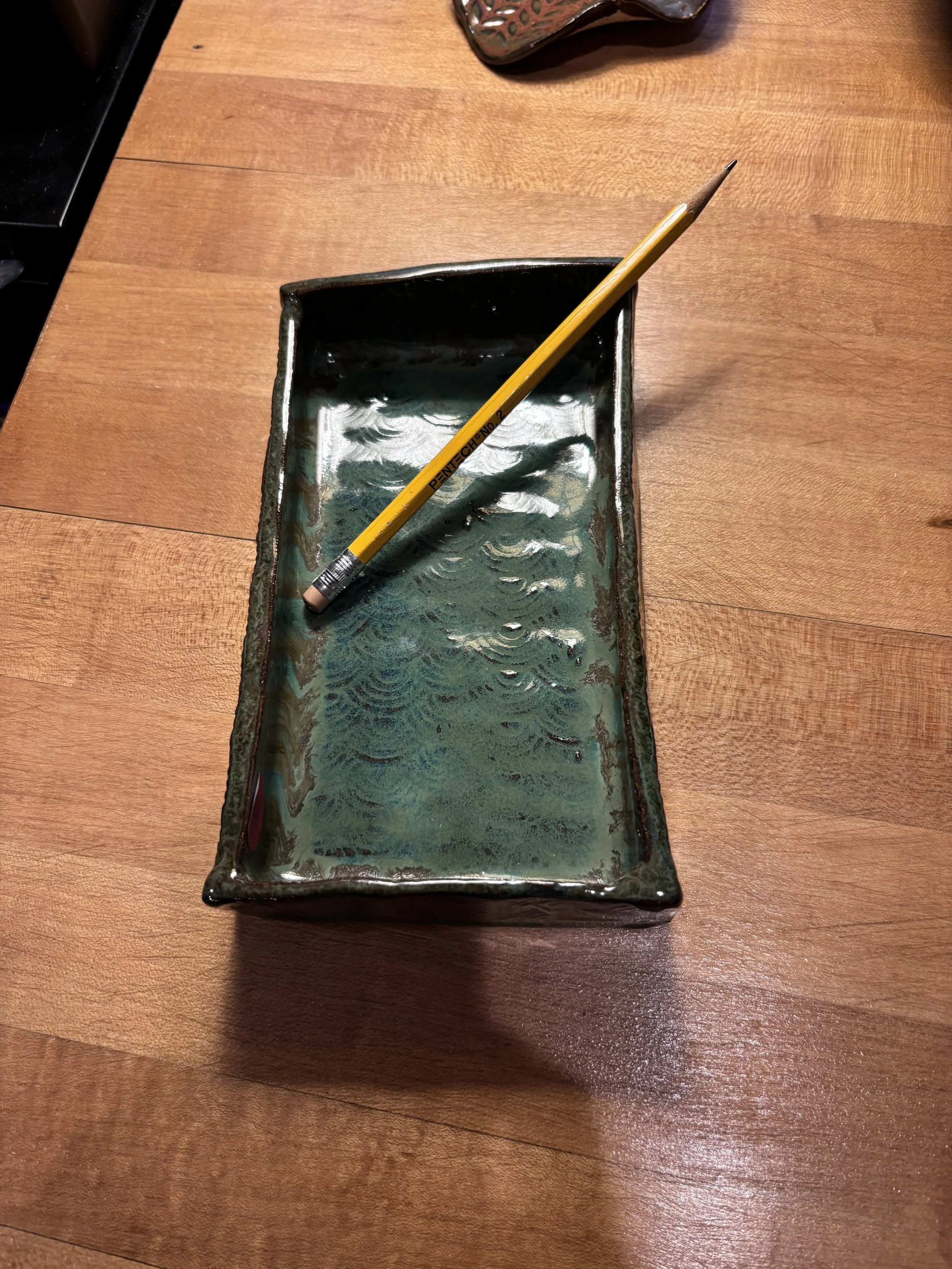 Tray on red clay. With pencil for perspective