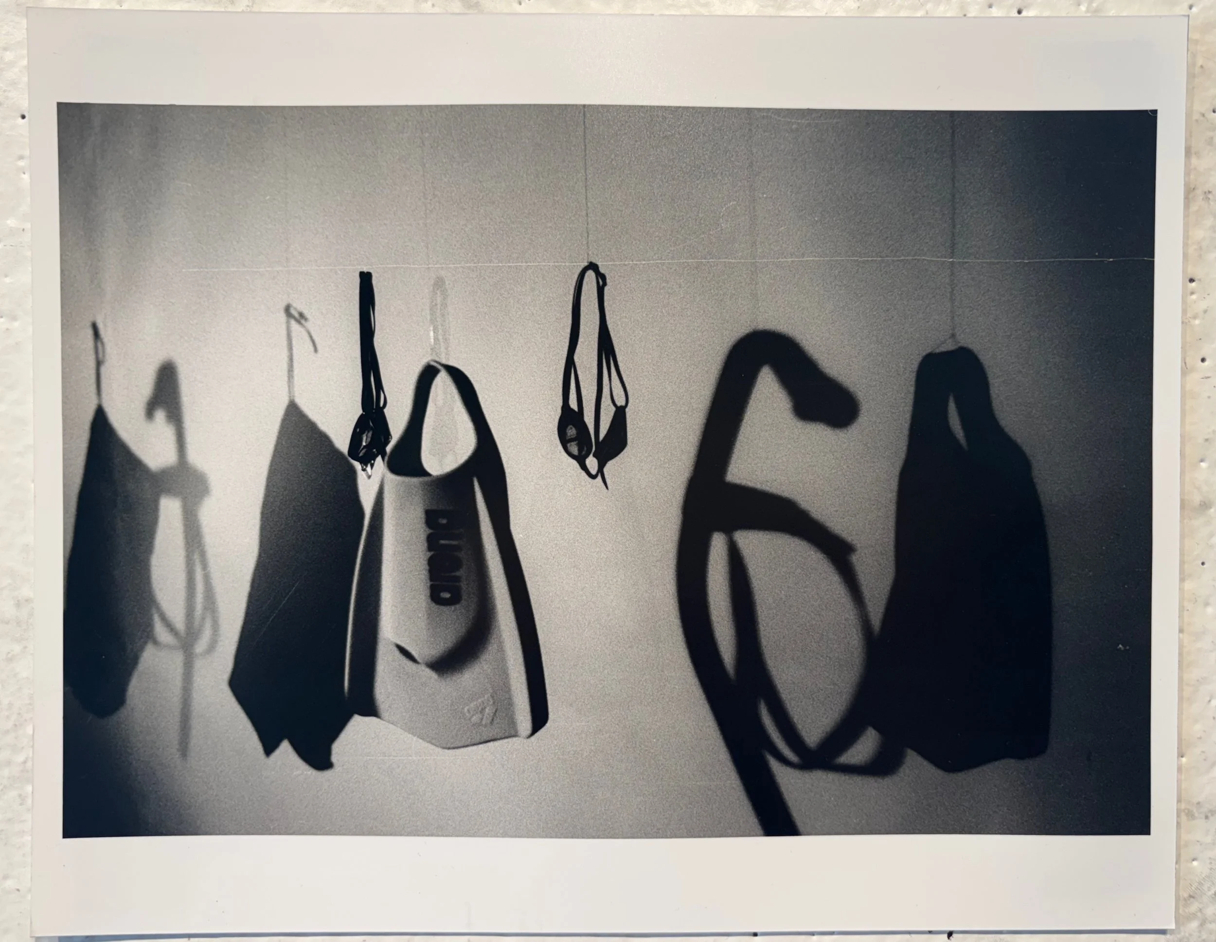 Part 1: Equipment Still Life
2025
Analog Photography
8 x 10 in
Still life of swimming equipment hung from the ceiling using fishing line. Shot on Ilford film with an ISO of 400 and developed the photo in the darkroom. Part of my photography final fro