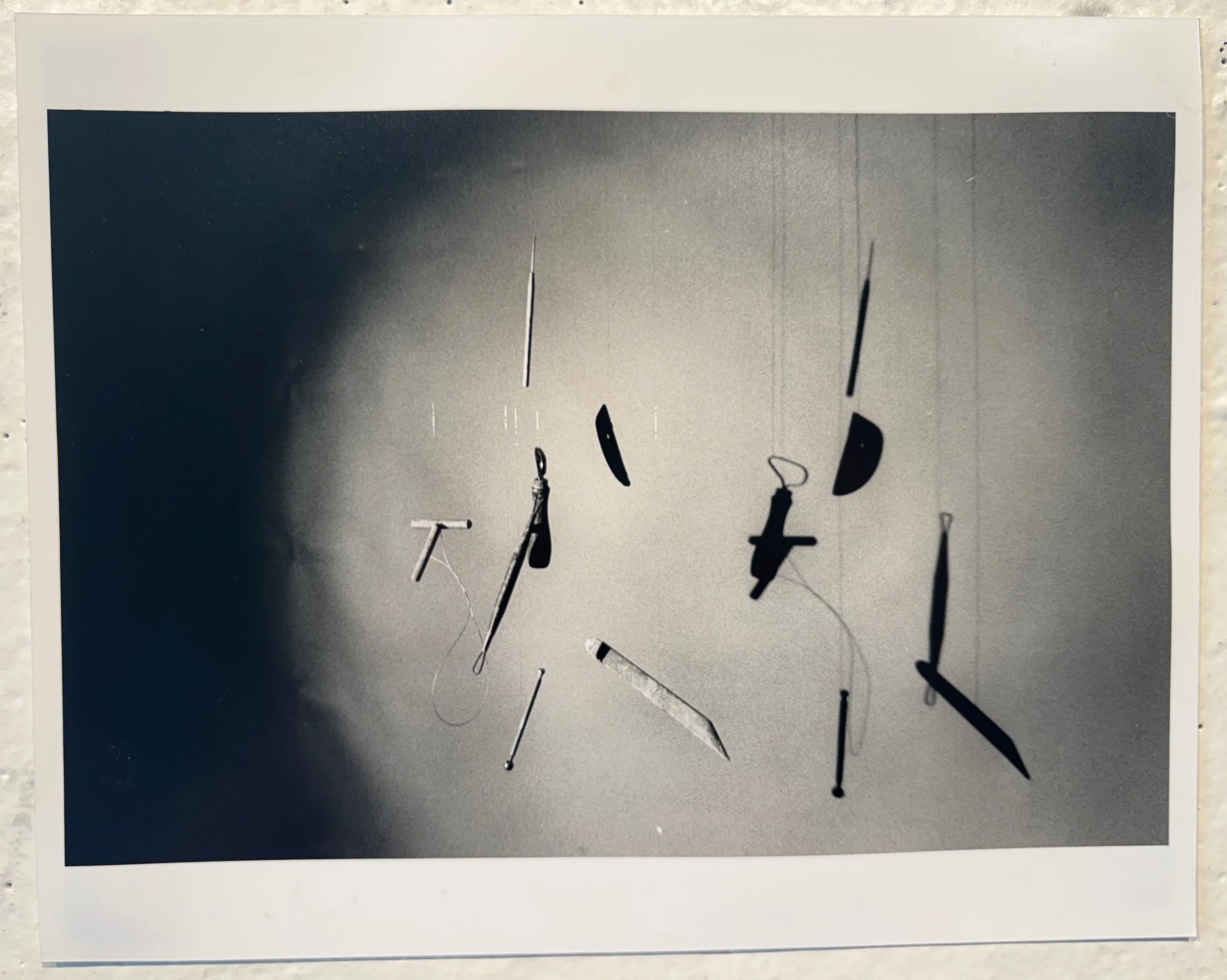 Part 2: Hanging Tool Still Life
2025
Analog Photography
8 x 10 in
Still life of ceramic tools hung from the ceiling using fishing line. Shot on Ilford film with an ISO of 400 and developed the photo in the darkroom.  Part of my photography final from