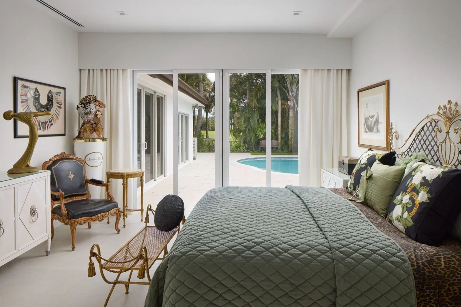 Calm bedroom with layered green bedding, soft lighting, and refined modern classic style