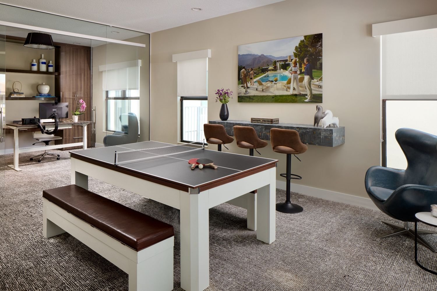 Modern game room with custom table, bar seating, and relaxed entertaining layout