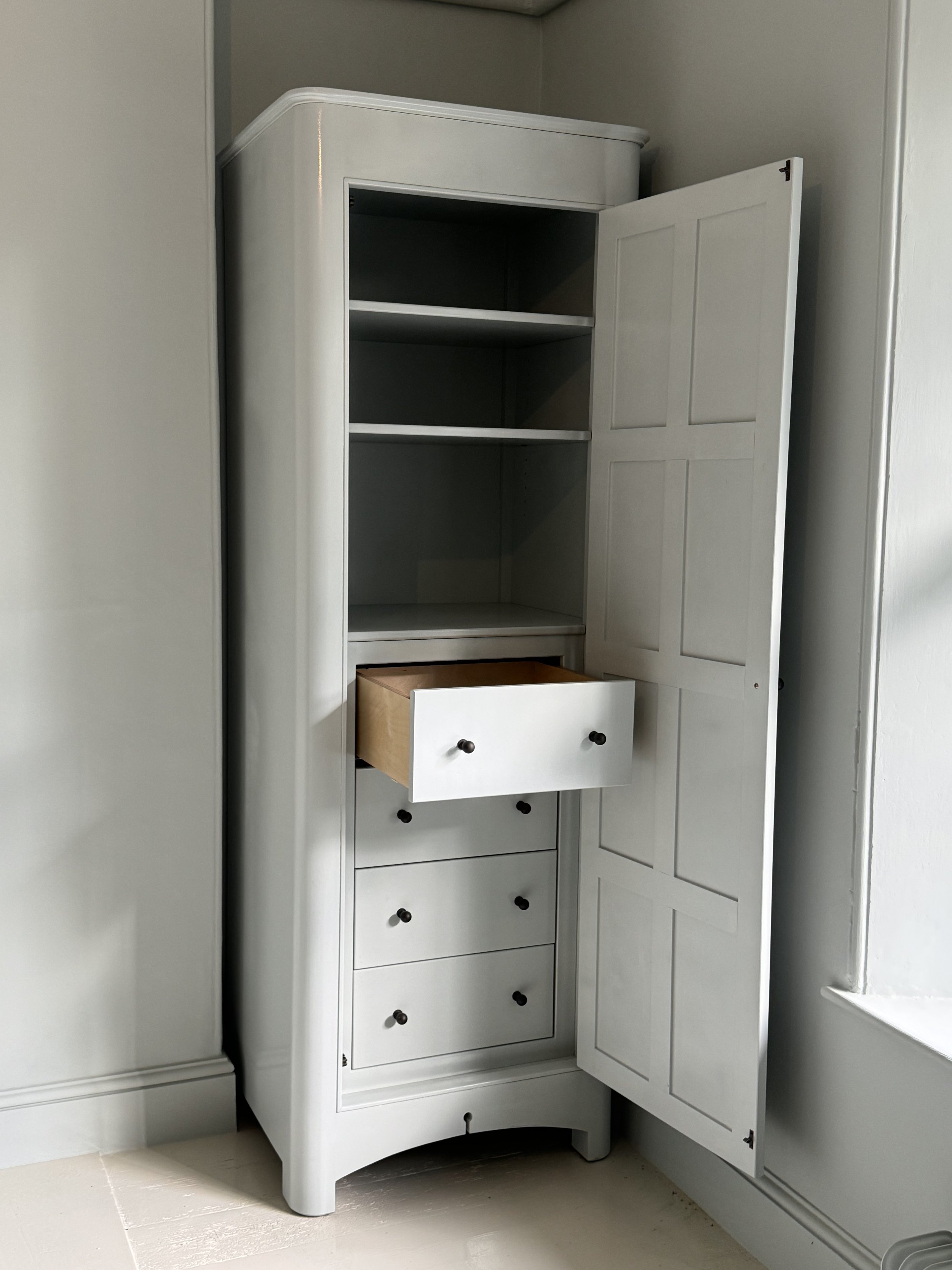 Finished bespoke freestanding wardrobe with 8 panel doors curved edge detailing