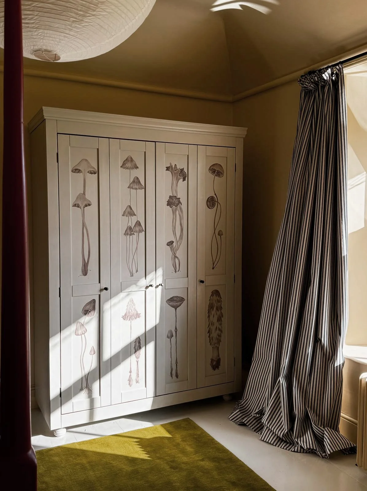 A bespoke double free standing wardrobe with bi-fold doors and interior hanging and drawers