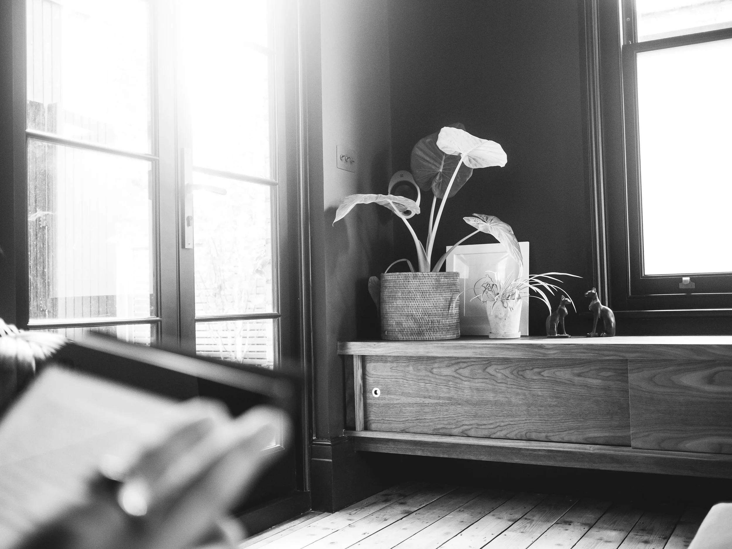 Bespoke minimal contemporary media unit made in solid and veneered walnut with brass pull handles, sliding doors and hidden LED lighting