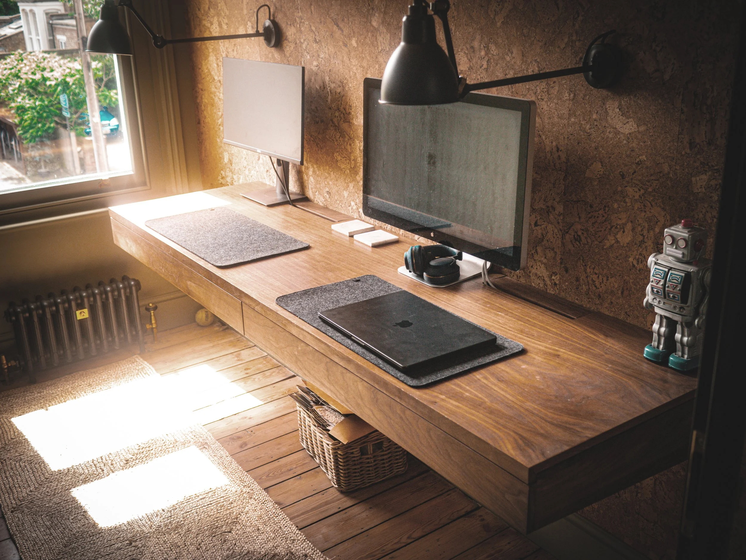 Bespoke study desk in veneered and solid walnut, hidden storage drawers cantilevered from cork accent wall