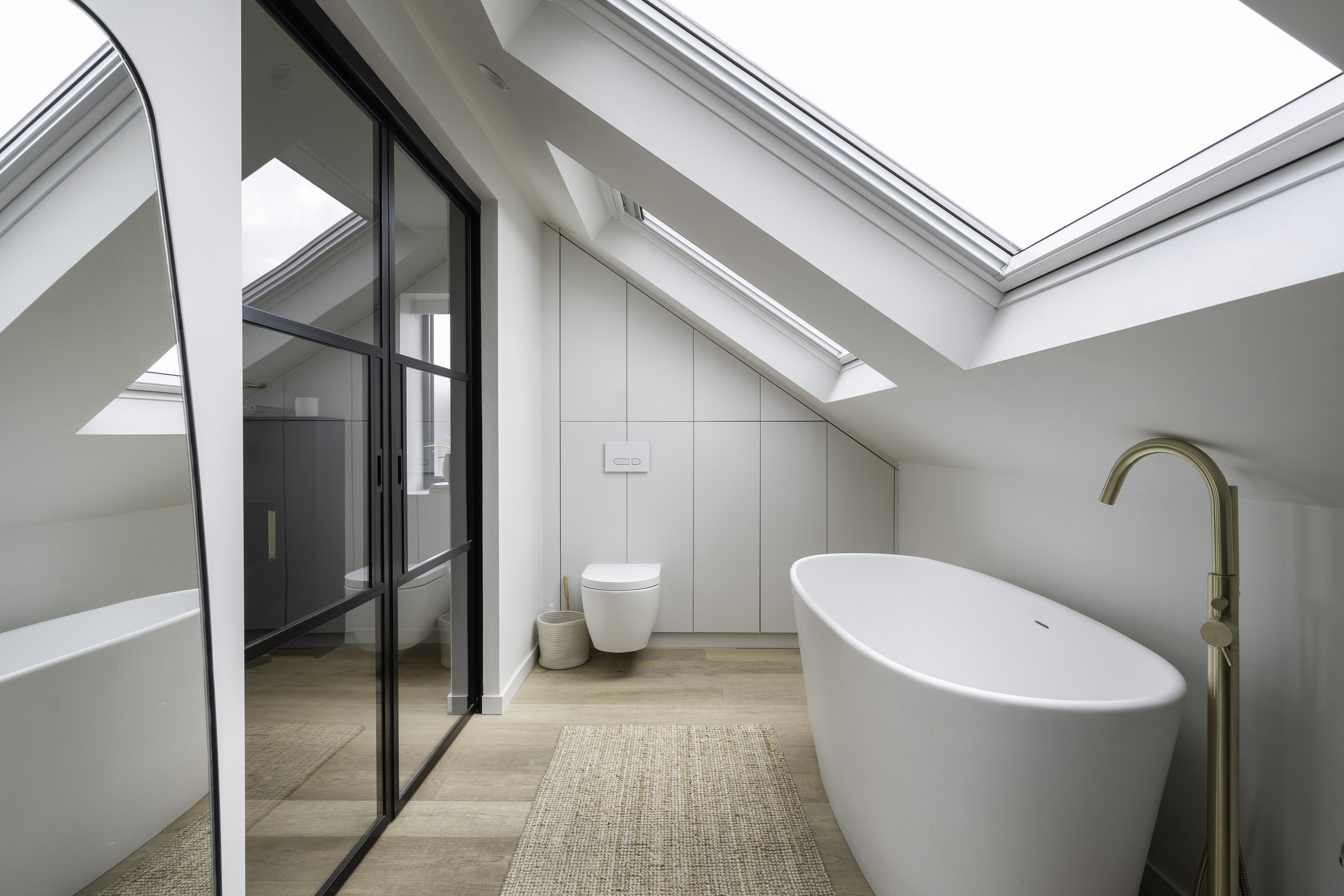 Bespoke fitted bathroom storage. Birch plywood carcasses finished in hard wax oil and painted doors with hidden push to open mechanism 