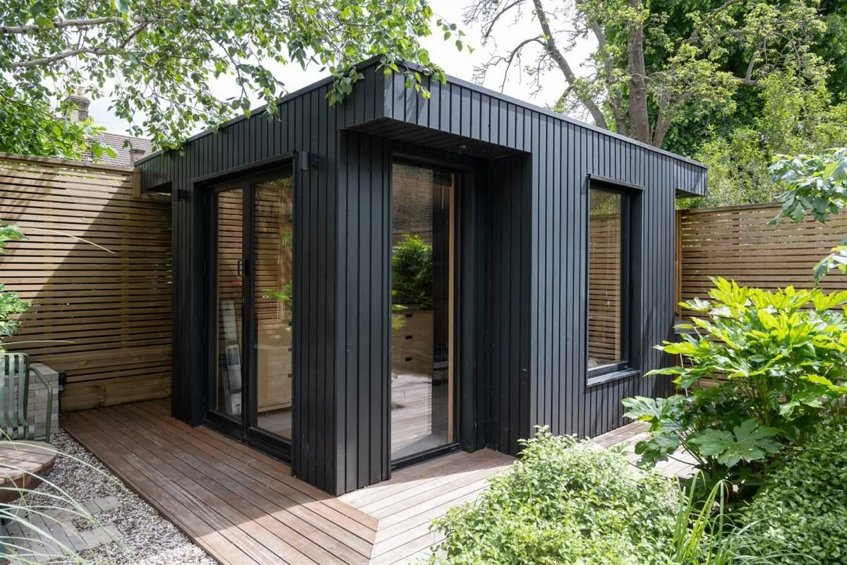 Bespoke garden room with hidden garden storage. EPDM roof, with hidden drainage Cortizo bi-fold door and windows, birch plywood interior and black stained larch cladding