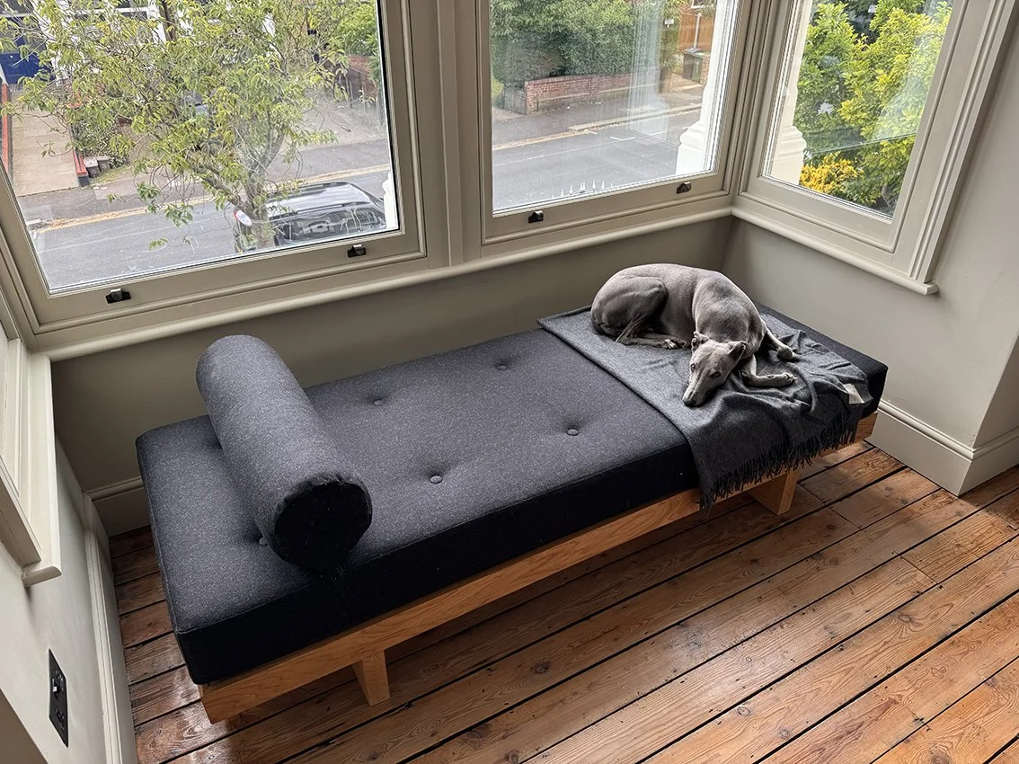 Bespoke contemporary minimal solid oak day bed with buttoned charcoal wool pad and head roll