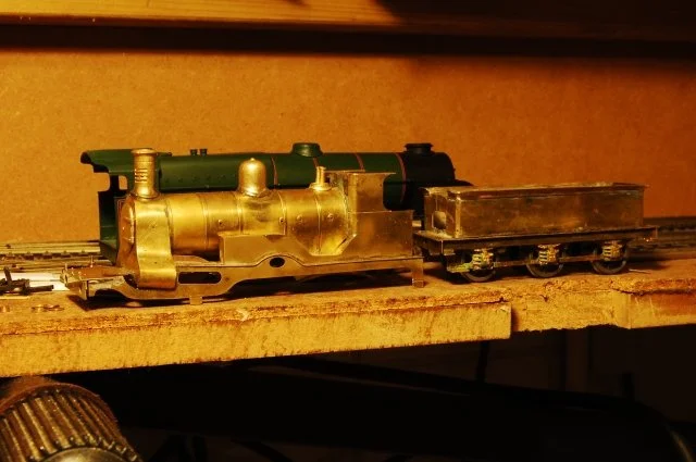 A model train on a wooden surface with a brown background.