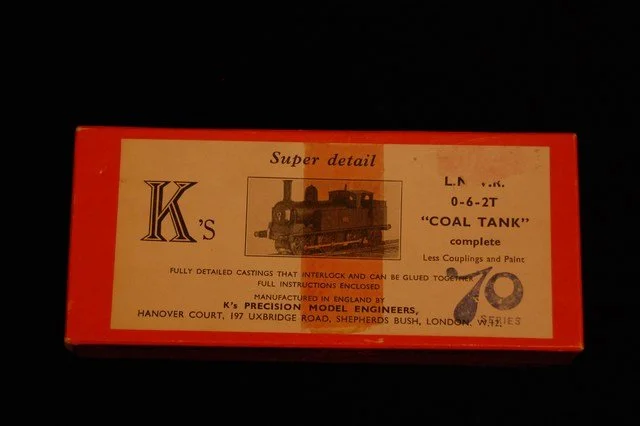 Red box packaging for a model train coal tank, featuring a black and white image of a steam locomotive and details about the model by K's Precision Model Engineers.