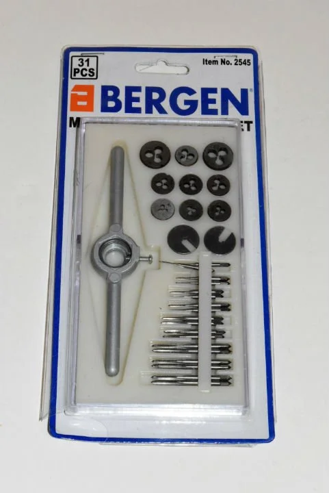 A Bergen sewing machine repair kit with various small parts, including black and gray plastic components, metal pins, and a tool, in a plastic packaging with a cardboard backing.