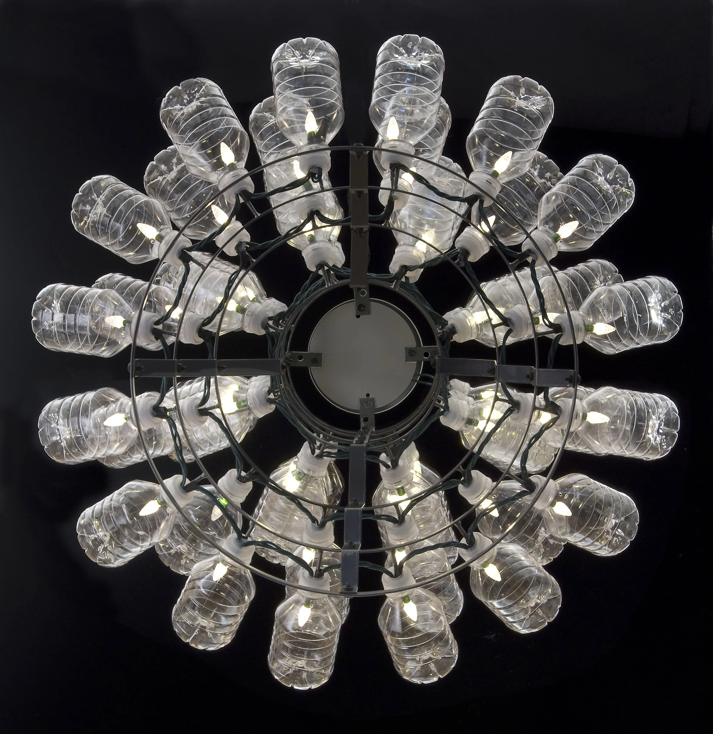 RECYCLED READYMADE, B, chandelier homage to M. Duchamp, recycled PETE water bottles, LED light, French-style metal bottle drying rack, 24" diam. x 30" h, 2010
