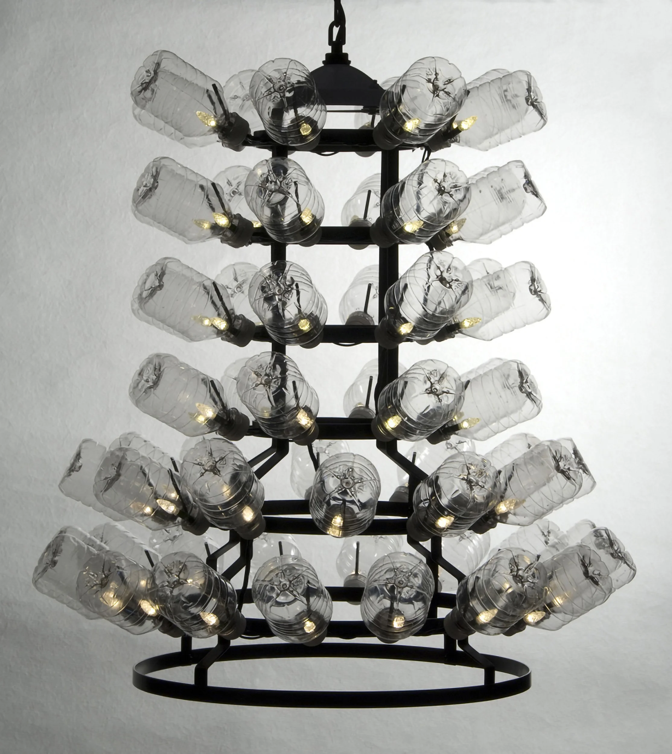 RECYCLED READYMADE, A, chandelier homage to M. Duchamp, recycled PETE water bottles, LED light, French-style metal bottle drying rack, 24" diam. x 30"h, 2010