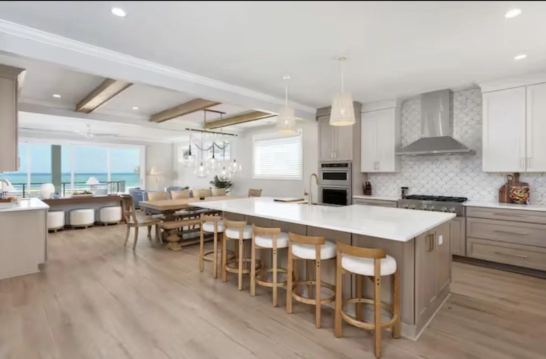 Thoughtful kitchen material selections bring this Kure Beach coastal home to life, with warm cabinetry, timeless countertops, custom tile, and curated hardware creating a refined yet relaxed beach house aesthetic.