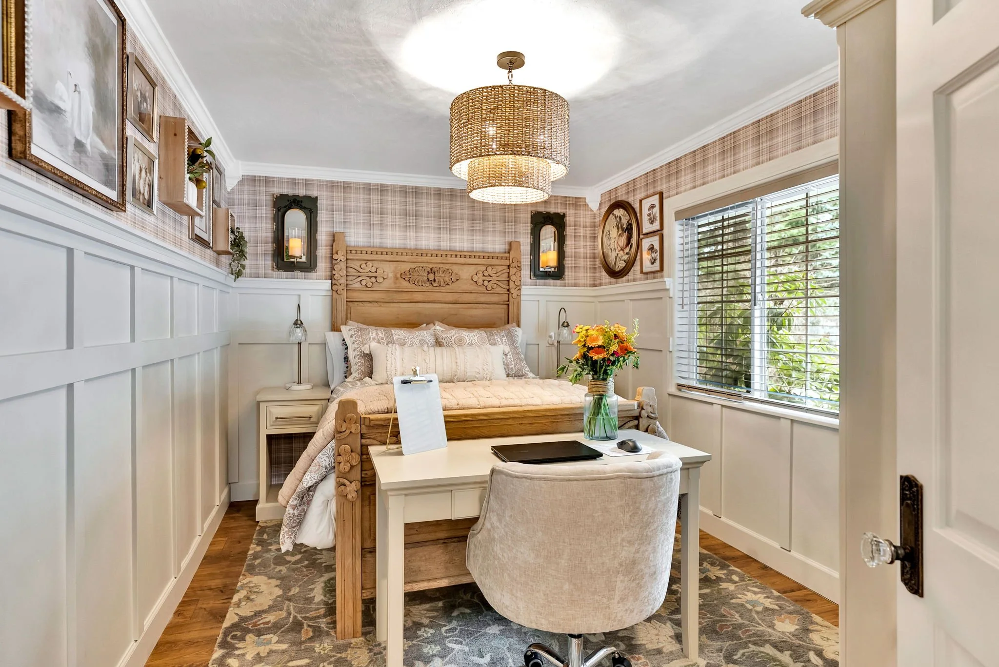 English cottage bedroom design in Bayview Idaho featuring plaid wallpaper, custom millwork, and vintage-inspired furnishings.