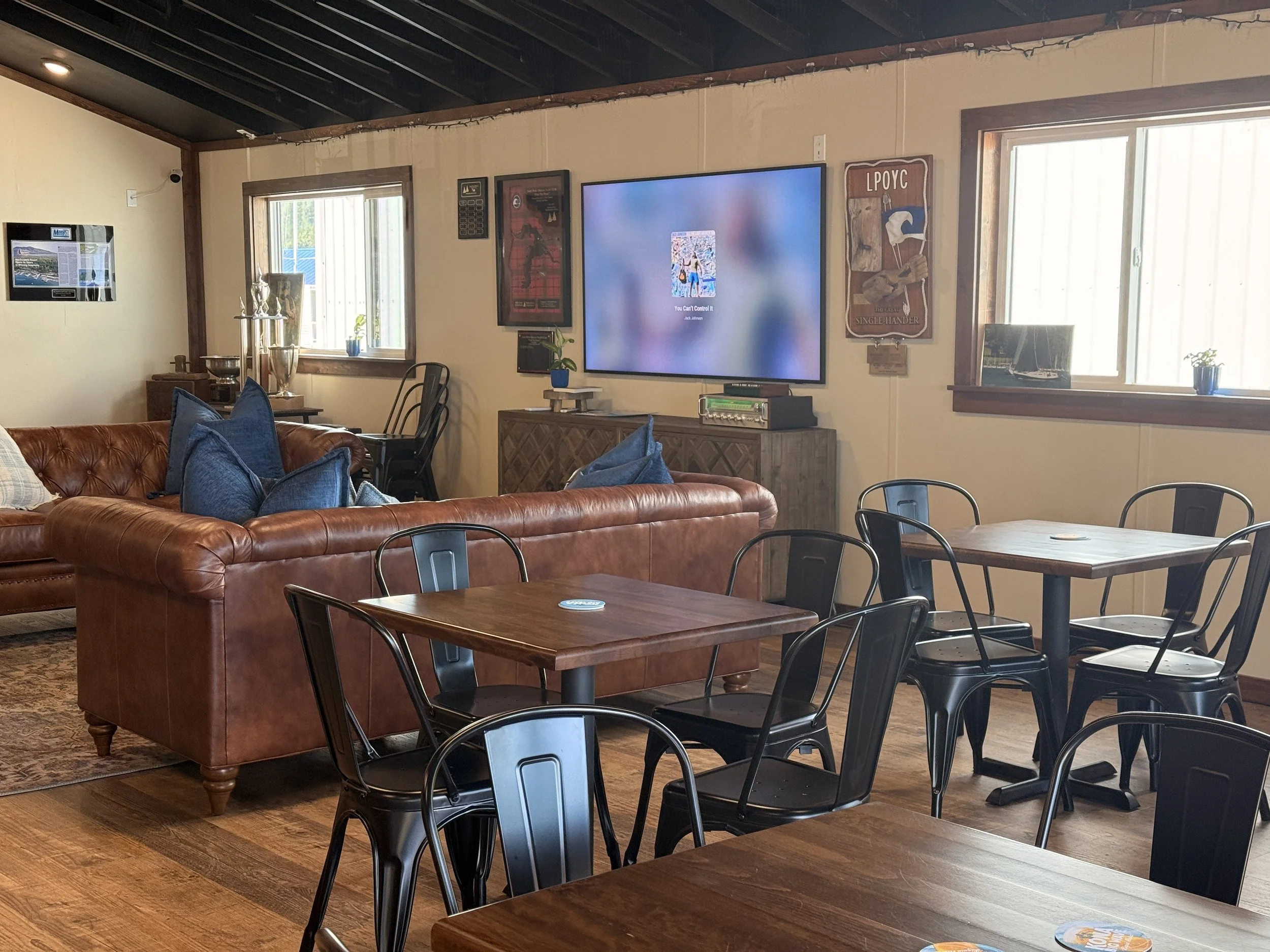 Blending comfort and function, this small café design features casual seating, flexible dining spaces, and layered textures that encourage connection and conversation.