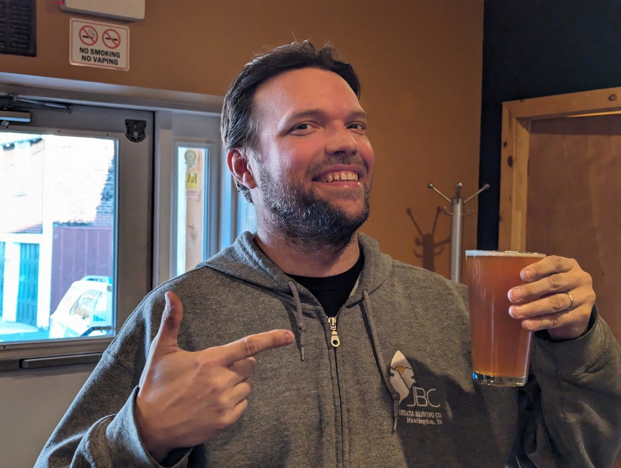 Sean Steeg pointing at a glass of beer