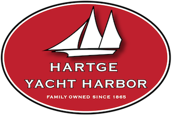 Logo for Hartge Yacht Harbor featuring a sailboat graphic and red background with white text.