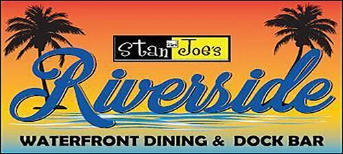 Sign for Stan and Joe's Riverside Waterfront Dining & Dock Bar with palm trees and a sunset background.