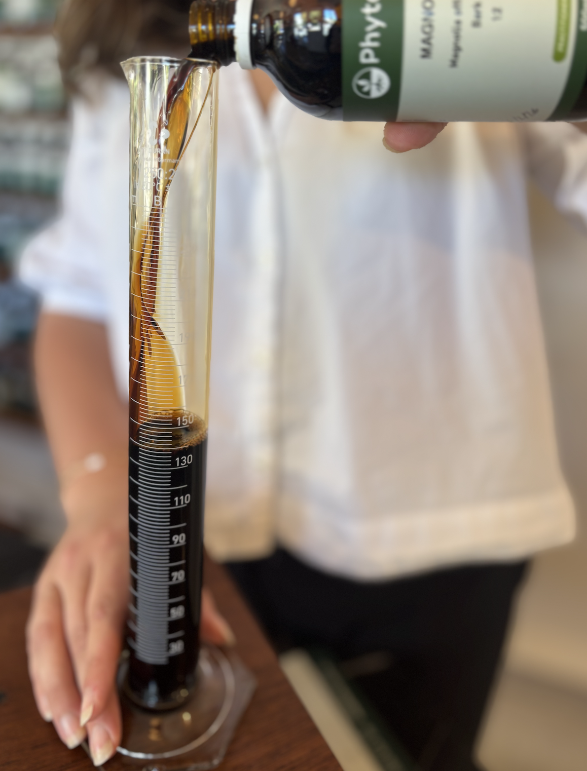 Pouring liquid herbs, Julia Neville, Soma Naturopathy