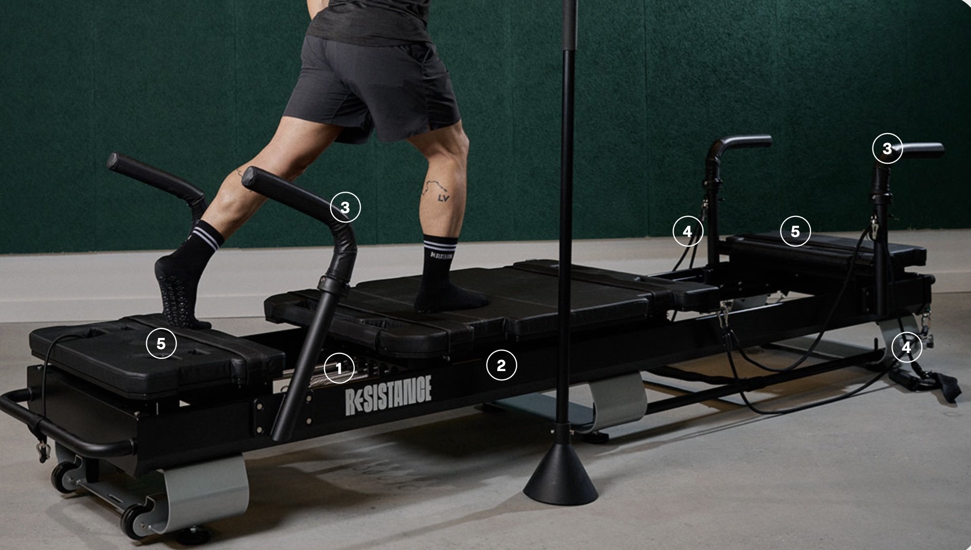 A person running on a treadmill with a resistance training device attached to the side.