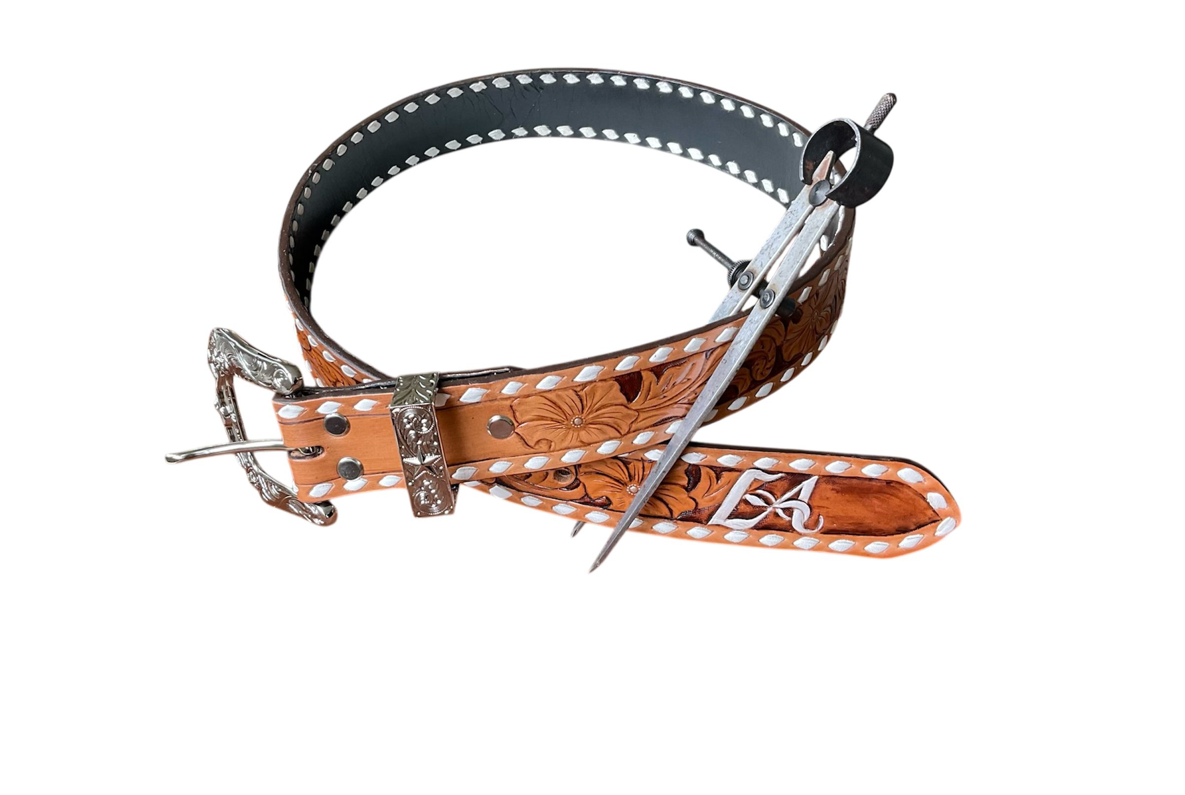 Western-style leather belt with floral design, silver buckle, and metal prong, laid flat.