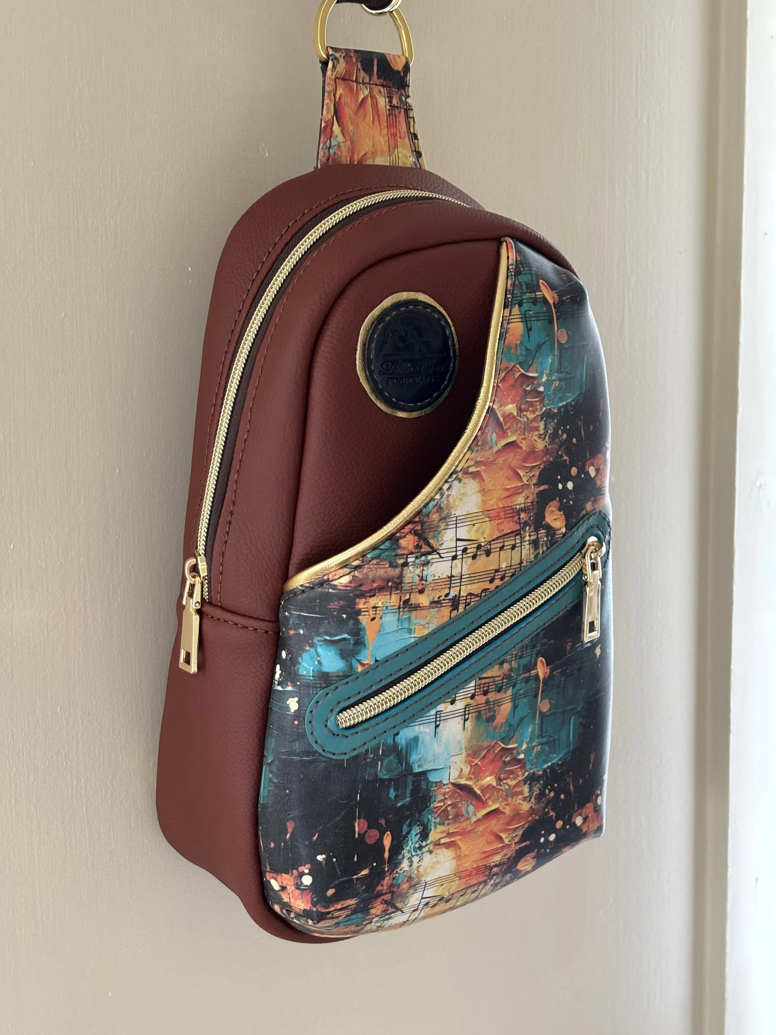 Machine sewn sling bag with music themed feature front.  These are probably my best selling machine sewn bag, designed by Knotted Threads Co patterns