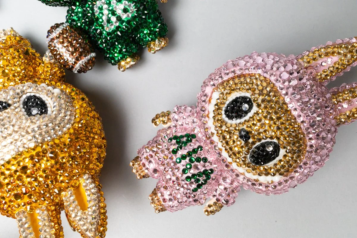 Rhinestone decorated dog and cat figurines with paw print and the word 'LOVE' in rhinestones.