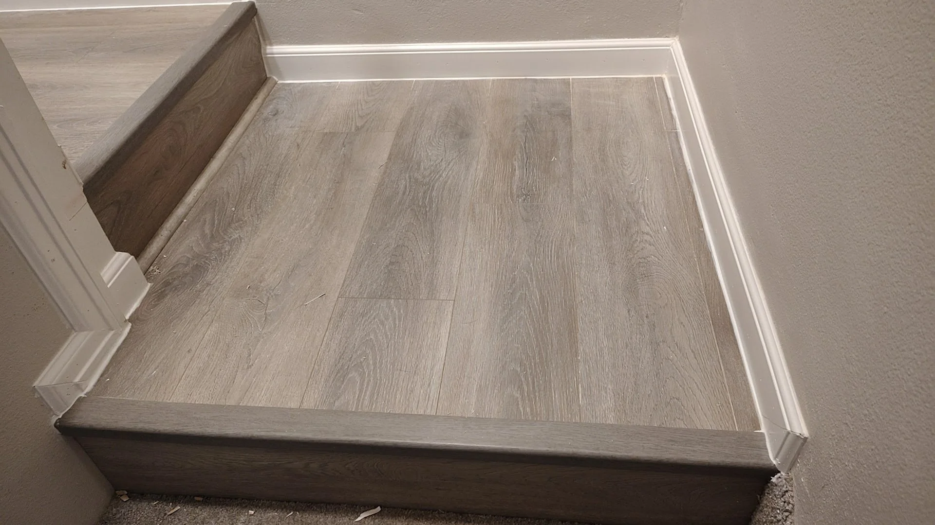 Small landing reflooring with new baseboard