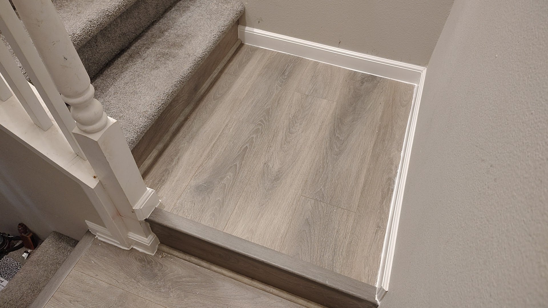 Small landing reflooring with new baseboard