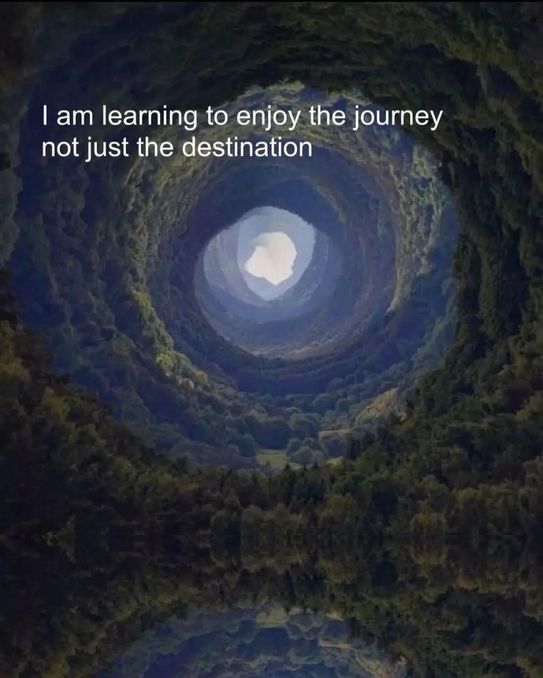 A scenic view of a tunnel with greenery on the sides and a light at the end, overlaid with the quote 'I am learning to enjoy the journey not just the destination'.
