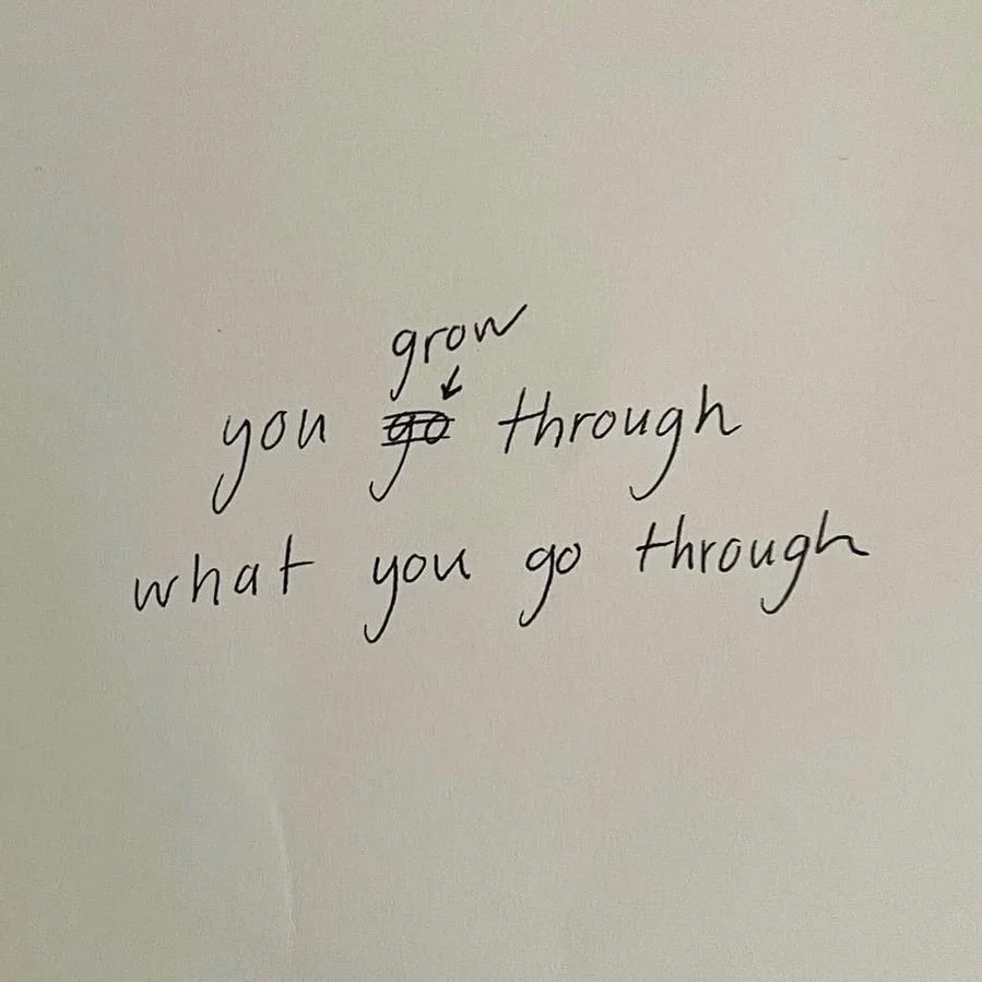 Handwritten note on paper with the words 'grow you go through what you go through' with an arrow pointing to the word 'go' indicating it should be crossed out.