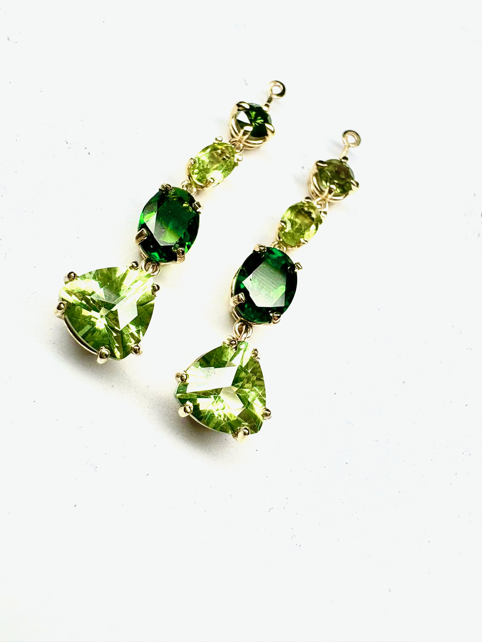 Yellow gold round, oval, and trilliant green tourmaline drop earring charms.