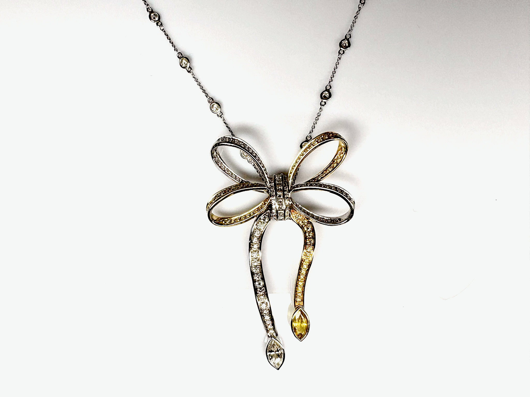 Custom two-tone yellow and white gold pendant with round radiant cut and marquise white and yellow diamonds, hand fabricated