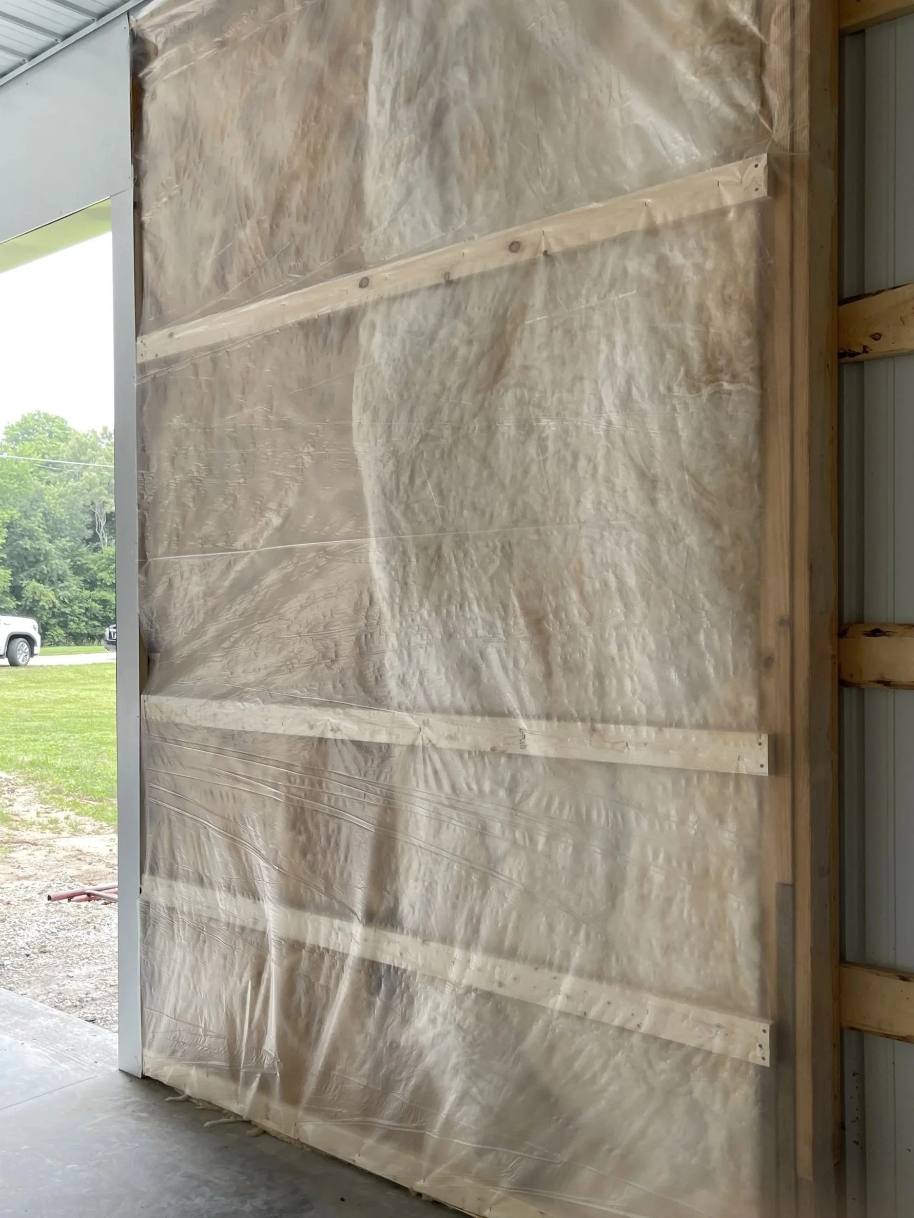Wall insulation with vapor barrier in metal building