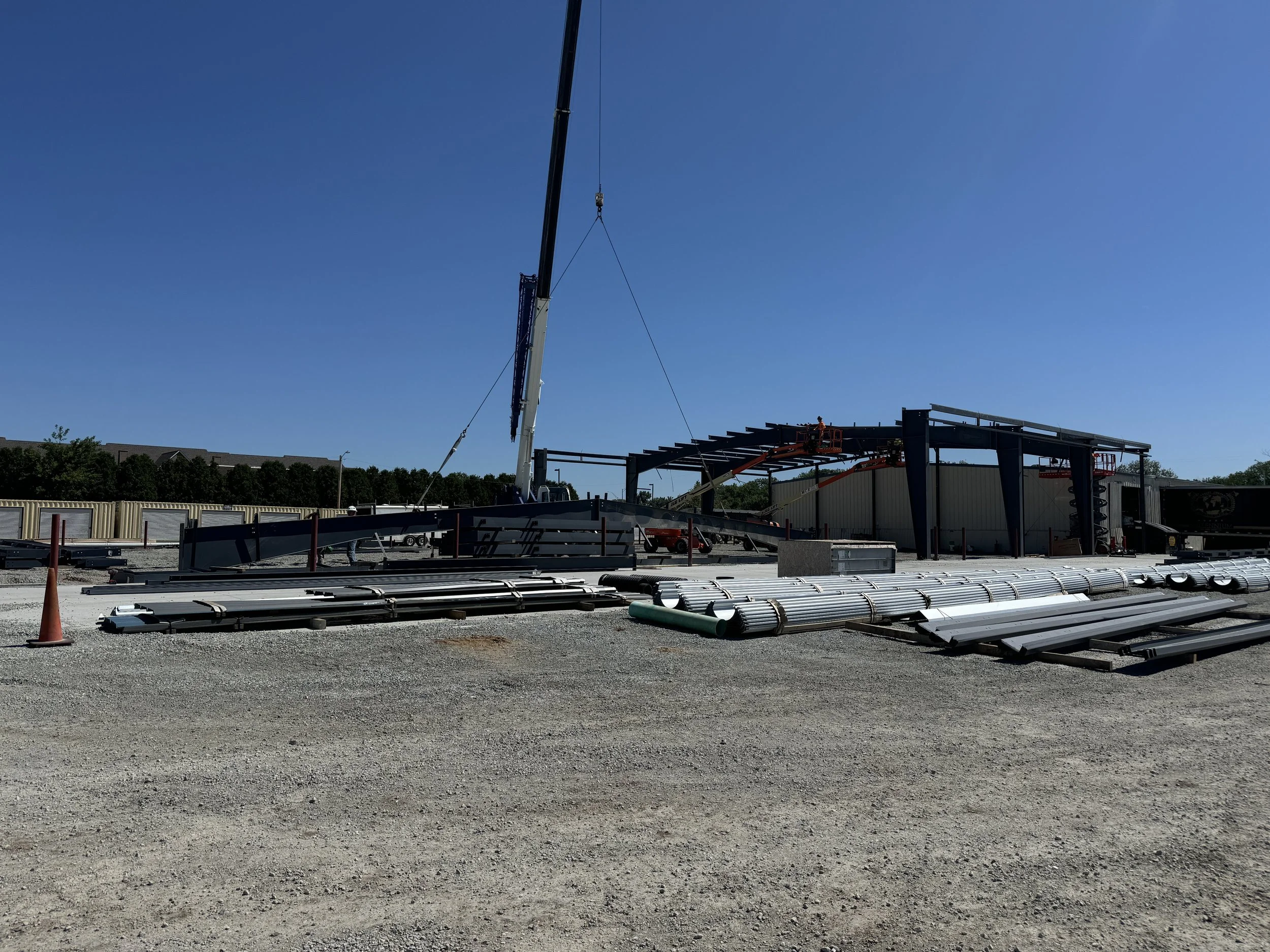 Steel building construction site with frame partially completed
