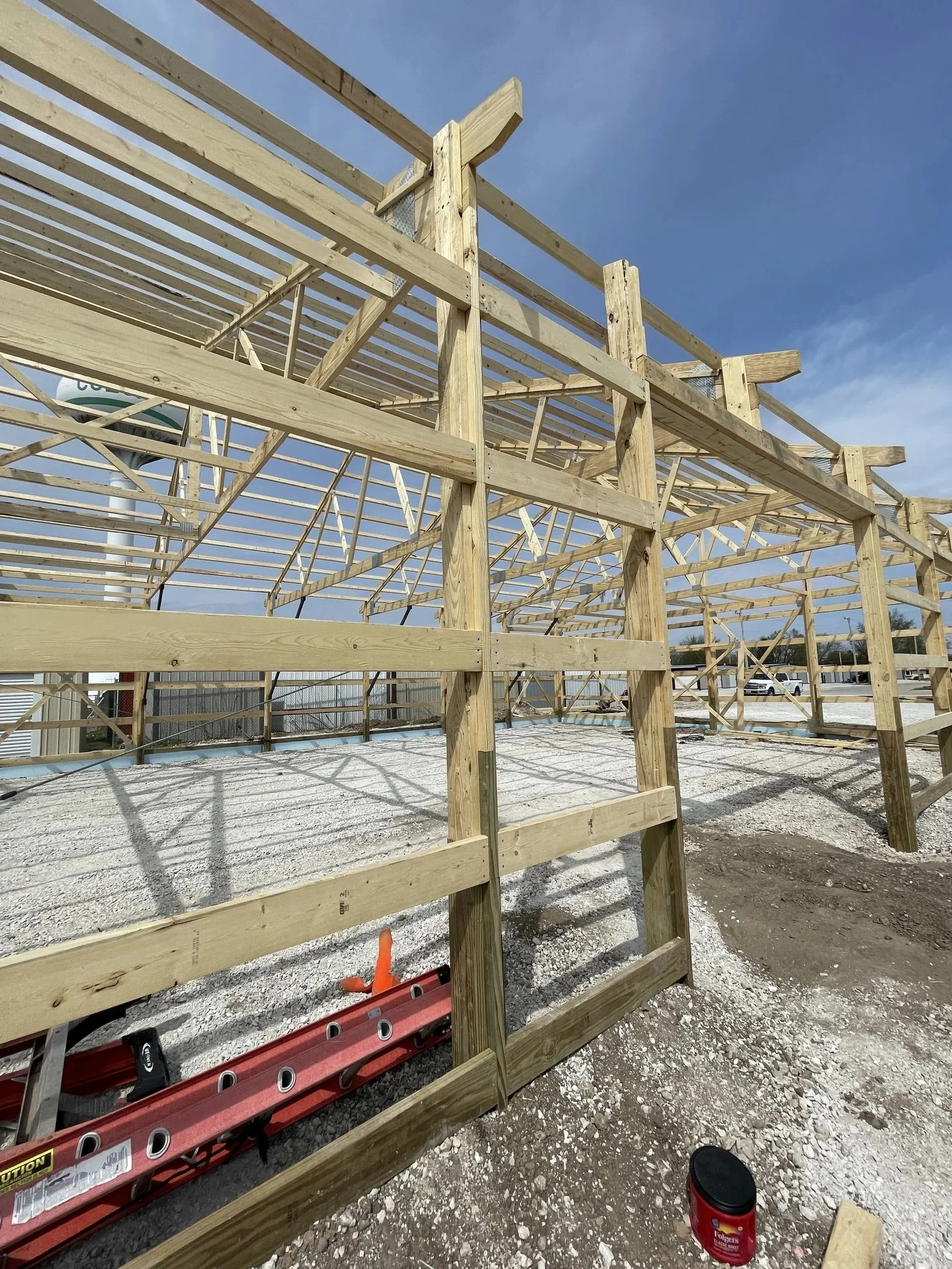 Post-frame wall framing with wood posts and girts installed