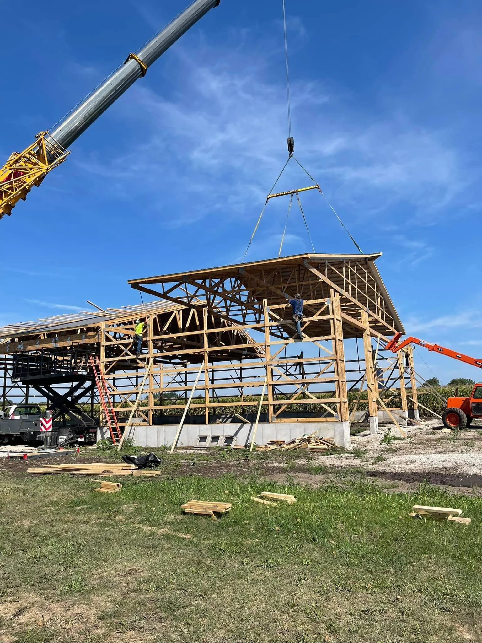 Construction crew installing engineered wood trusses