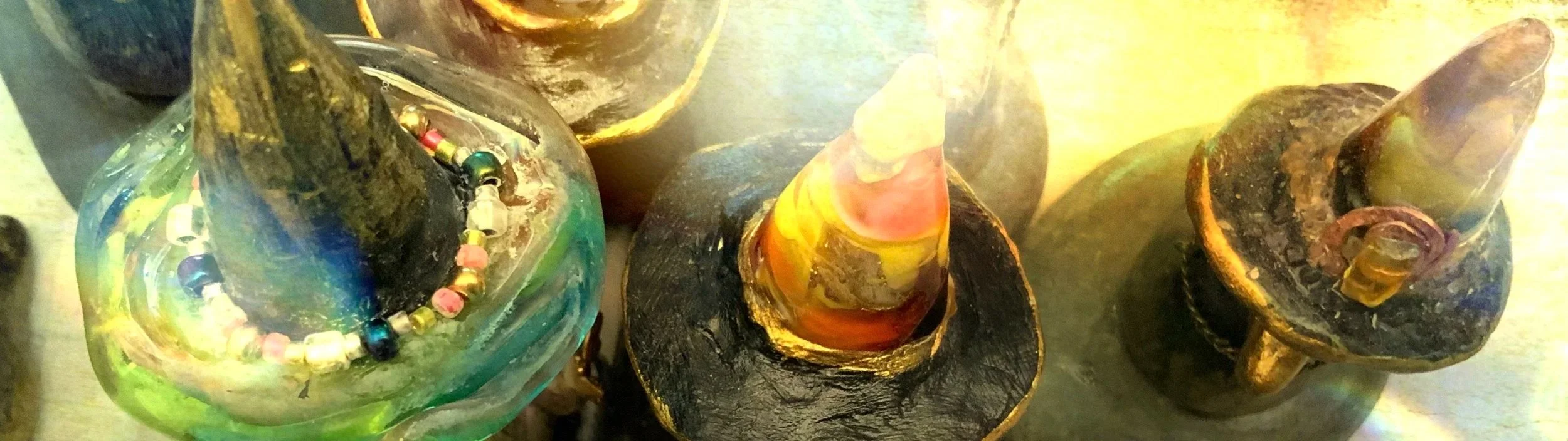 Colorful glass and ceramic decorative objects with abstract shapes and beads.