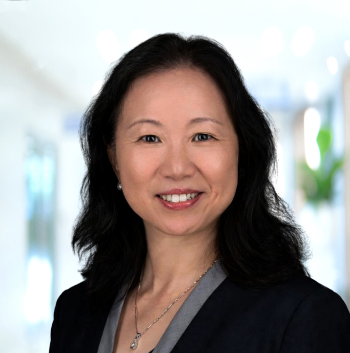 Professional portrait of Liangsu Wang, PhD Chief Scientific Officer of Caldera Therapeutics with dark hair, smiling, in a business setting with blurred background.