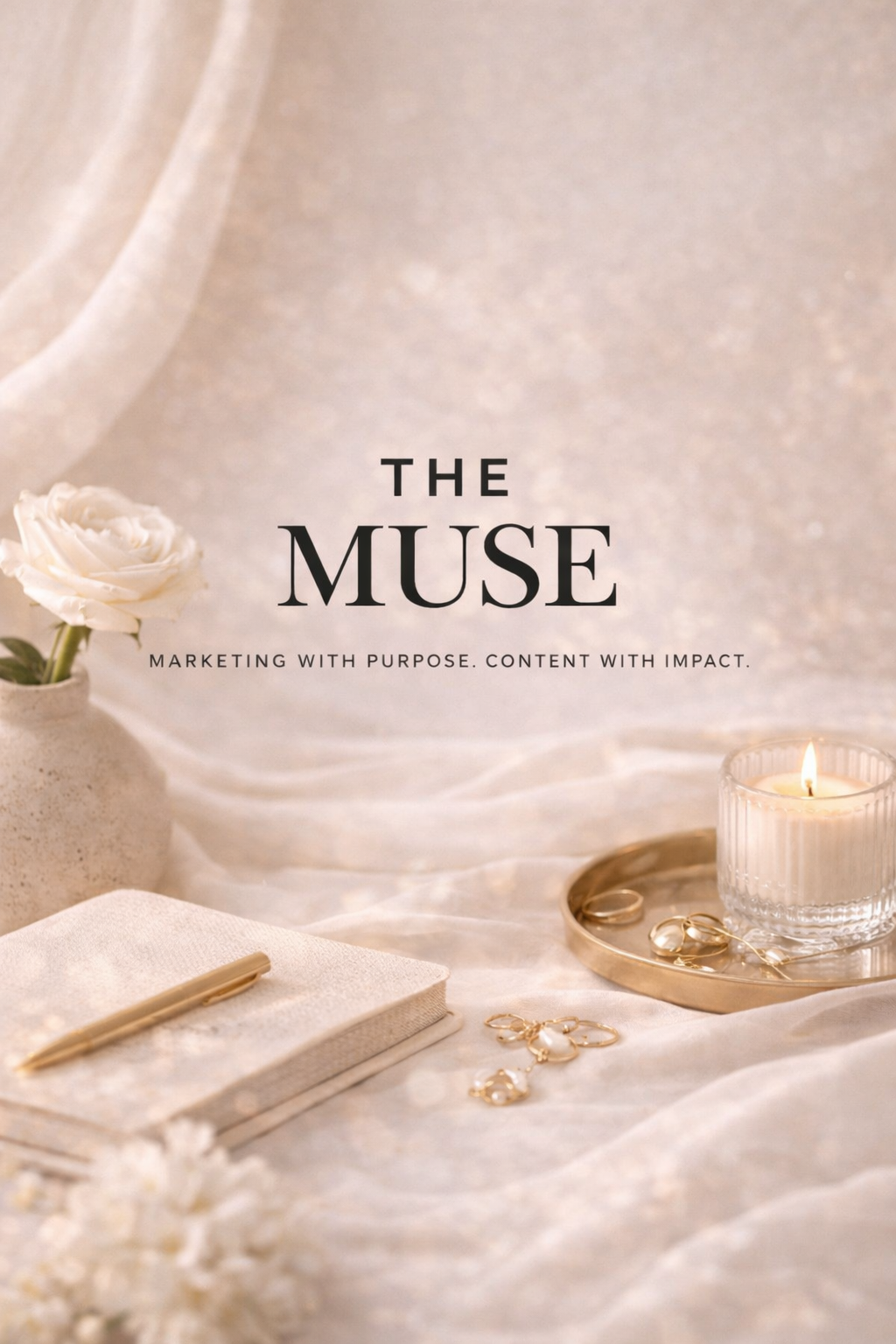 Elegant cream-colored background with white rose in a vase, gold jewelry, a notebook with a gold pen, and a lit candle, with text 'The Muse: Marketing with Purpose. Content with Impact.'