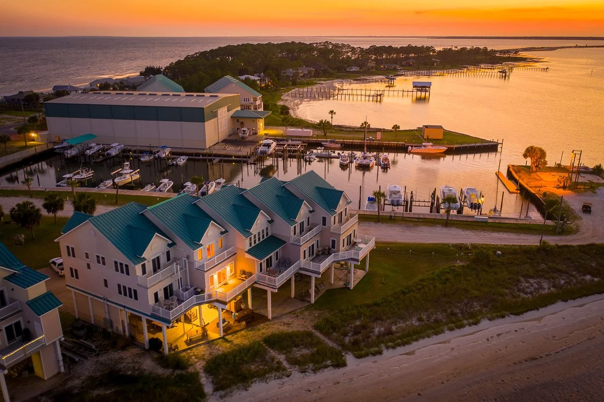 Aerial Real Estate photo of a view of a beach front condo at sunset.